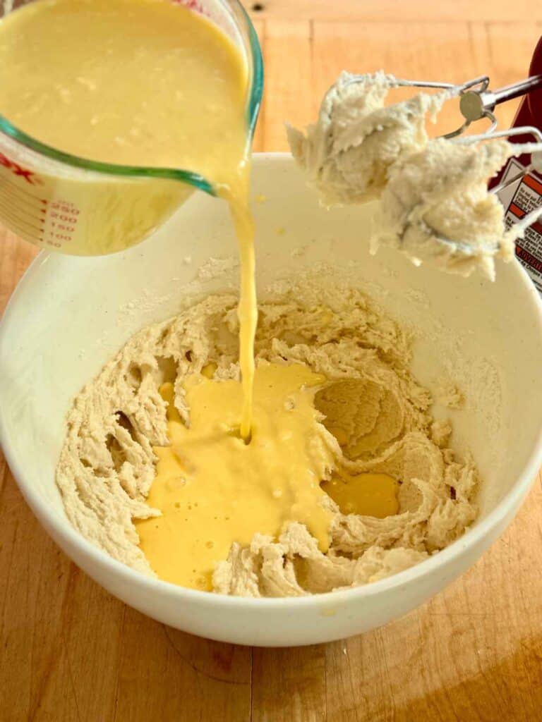 wet ingredients being poured into batter
