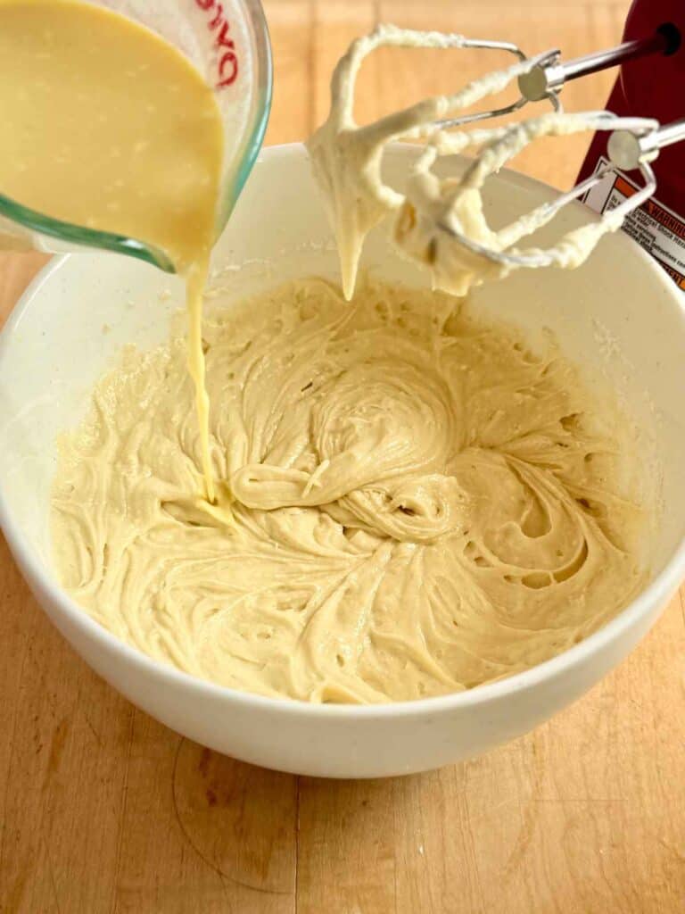 pouring second portion of wet ingredients into batter
