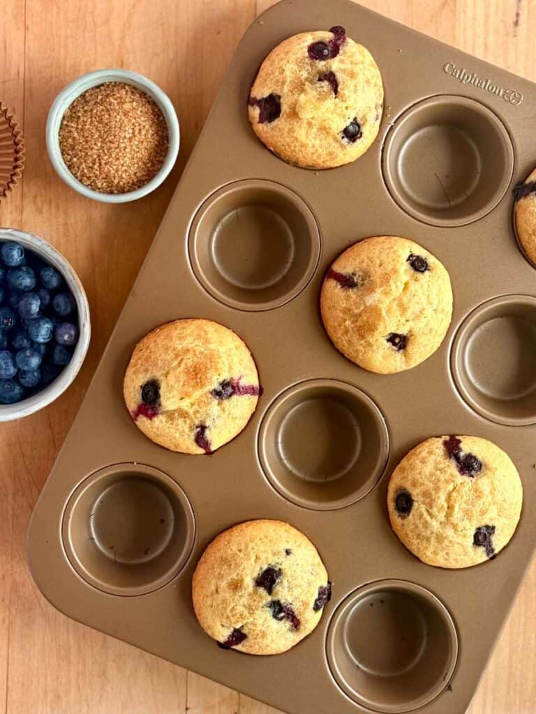 bakery style blueberry muffins baked in muffin tin 