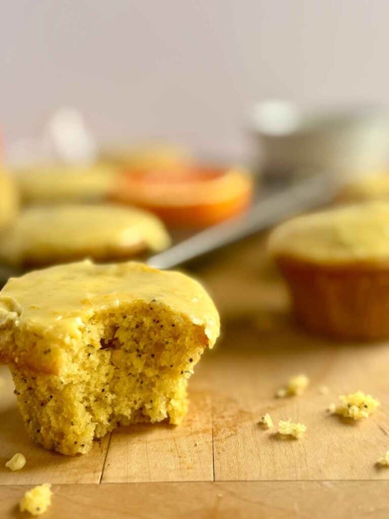 orange poppy seed muffin with bite taken out 