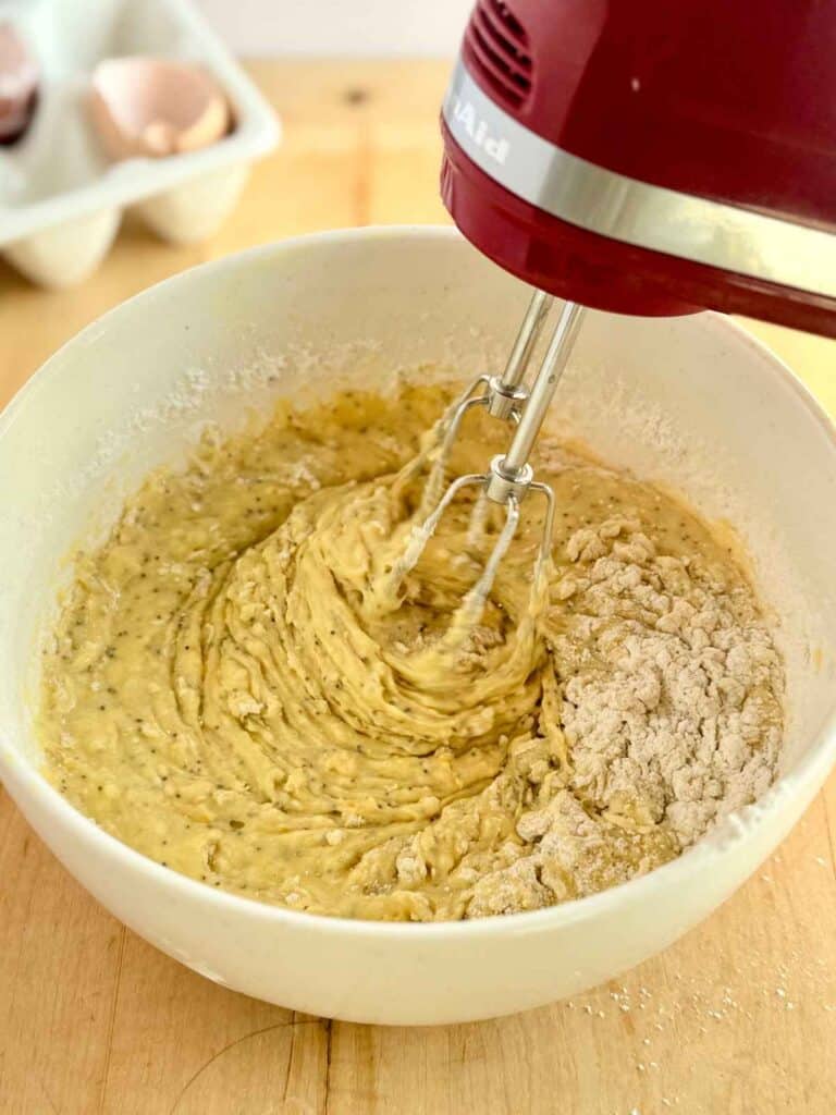 mixing dry ingredients into orange poppy seed muffin batter 