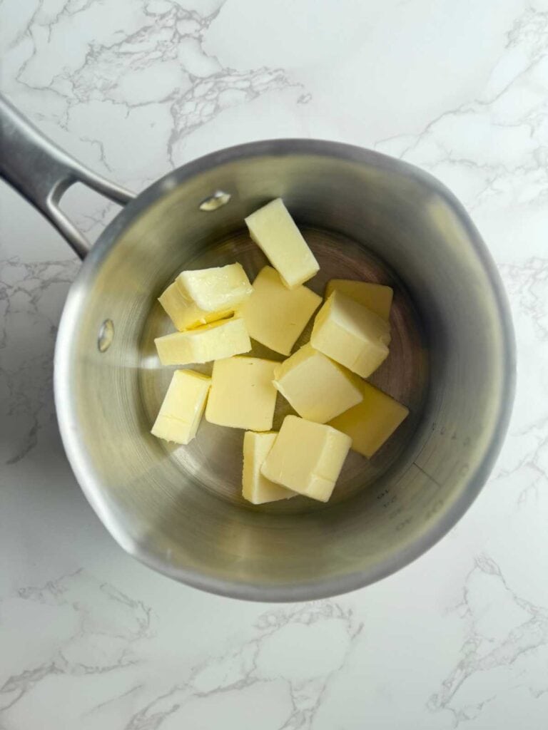 butter in pot before meting and browning for sourdough brown butter chocolate chip cookies 