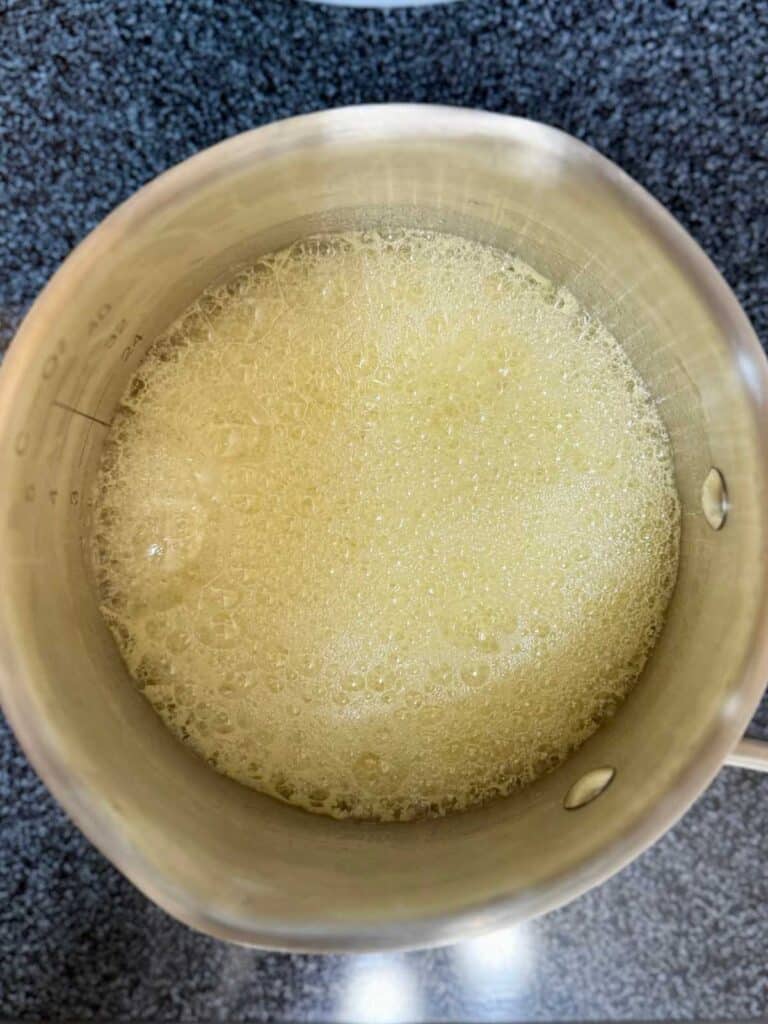 stage 2 of melted butter in pot before browning for sourdough brown butter chocolate chip cookies 