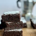 espresso brownies-stack of brownies on wooden board with espresso pot in background