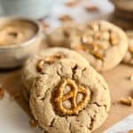 peanut butter pretzel cookies-close up of cookie with pretzels and peanut butter in background