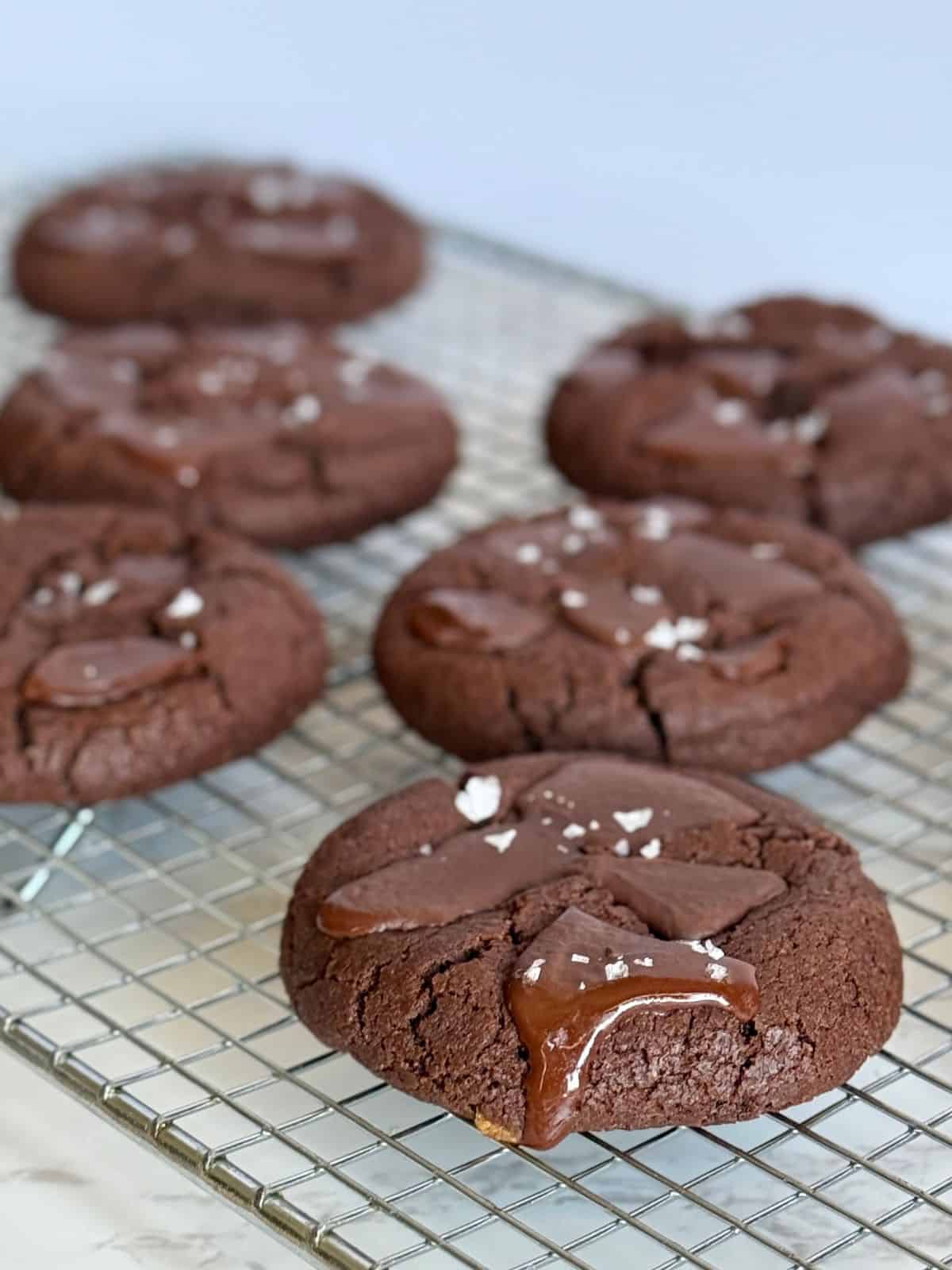 double dark chocolate cookies-cookies on cooling rack with dripping chocolate
