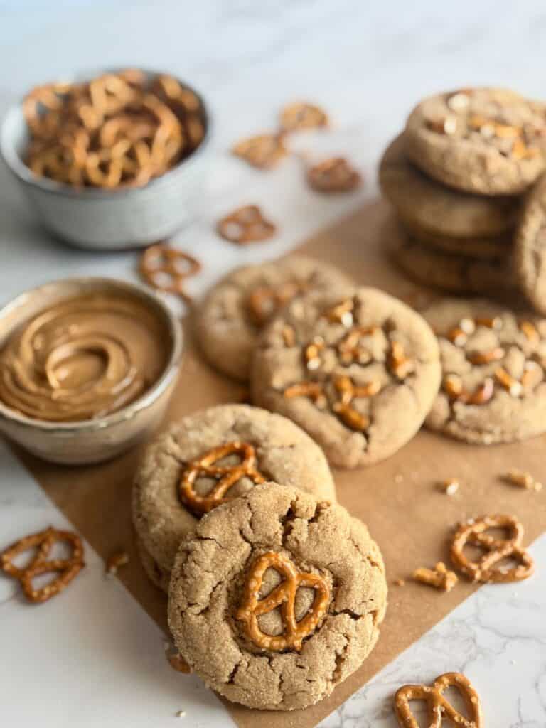 peanut butter pretzels cookies-cookies stacked and arranges with pretzels and peanut butter in the background