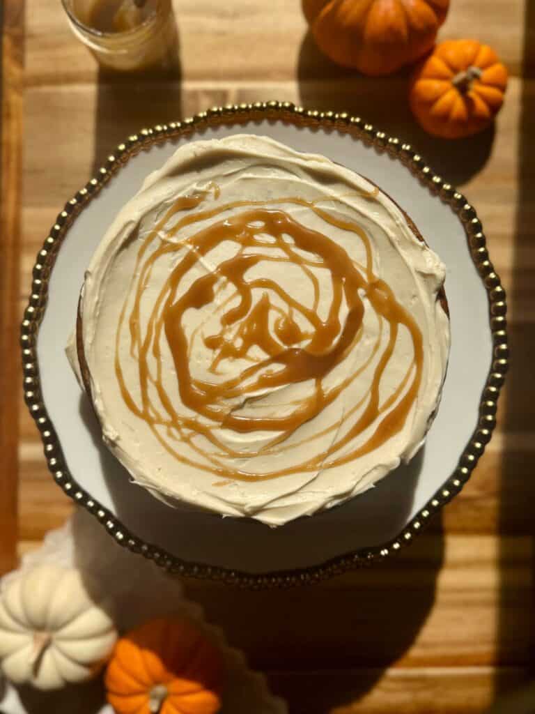 brown butter pumpkin cake- building the cake-cake layer with cream cheese frosting and butterscotch drizzle