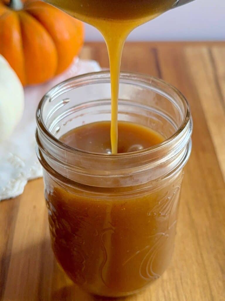 brown butter pumpkin cake-butterscotch sauce being poured into jar