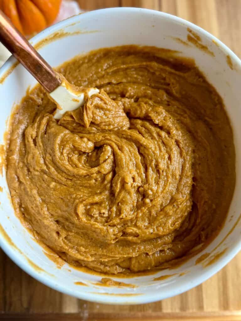 brown butter pumpkin cake-pumpkin cake batter mixed in bowl with spatula