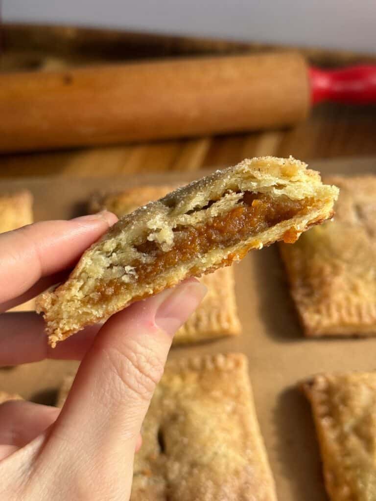 sweet potato hand pies - pie cut in half showing flaky crust and sweet potato filling