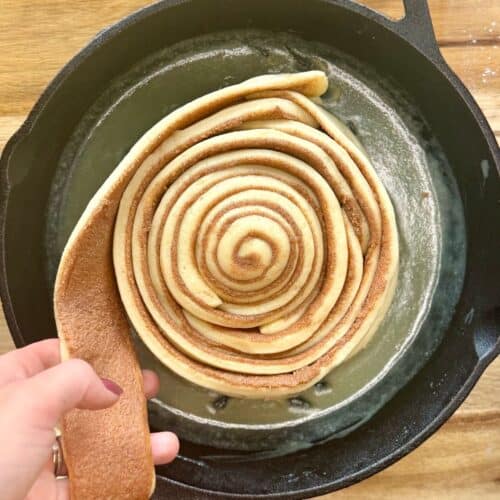 cast iron skillet cinnamon roll assembling strips of roll in skillet