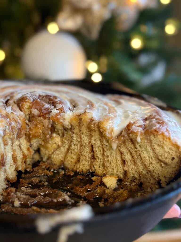 cast iron skillet cinnamon roll cut showing all the layers in the skillet