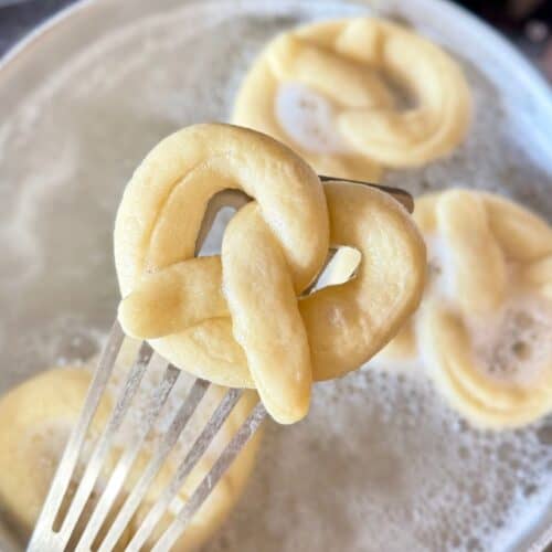 mini soft pretzels-pretzel after being dipped in baking soda on spatula