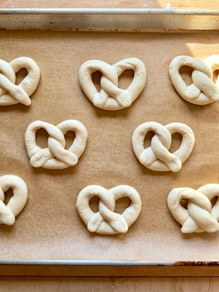 mini soft pretzels-shaped pretzels on baking sheet before baking
