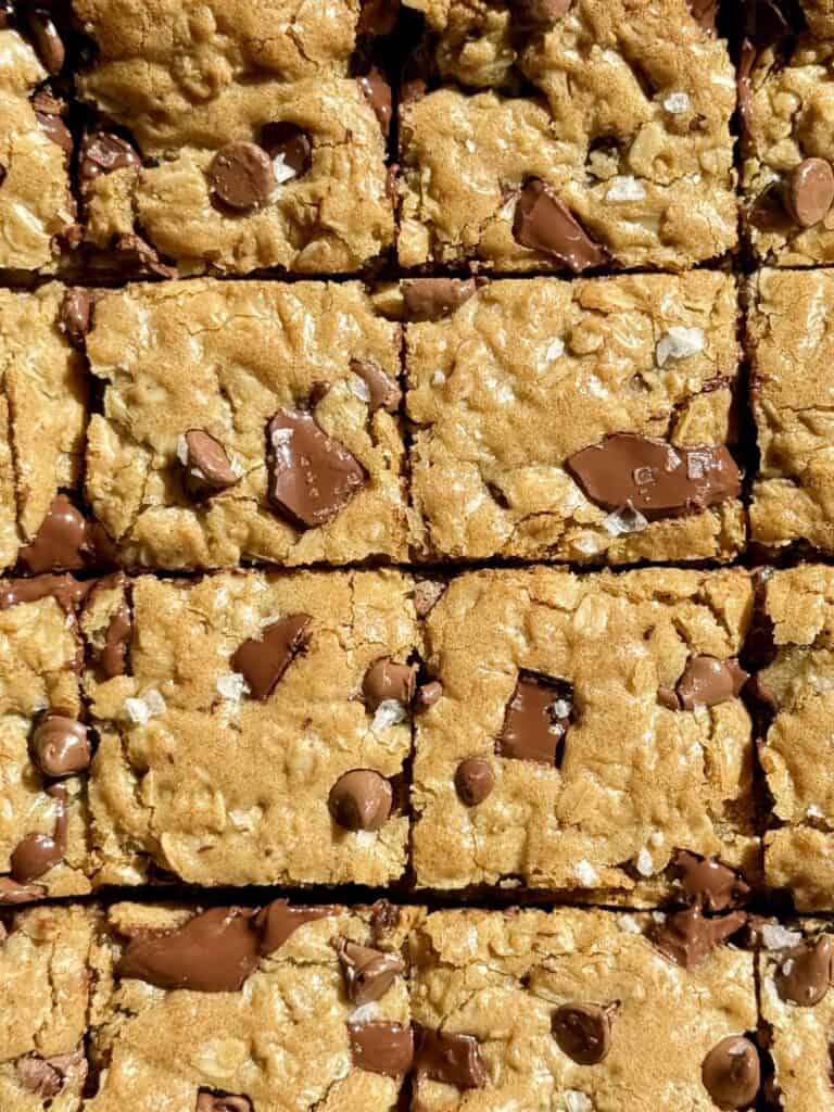 oatmeal chocolate chip cookie bars cut into squares topped with flaky salt
