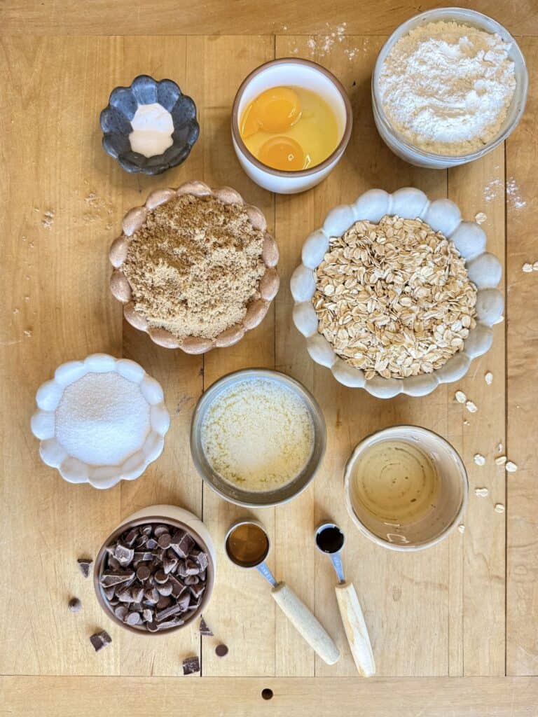 oatmeal chocolate chip cookie bars ingredients arranged on wooden board
