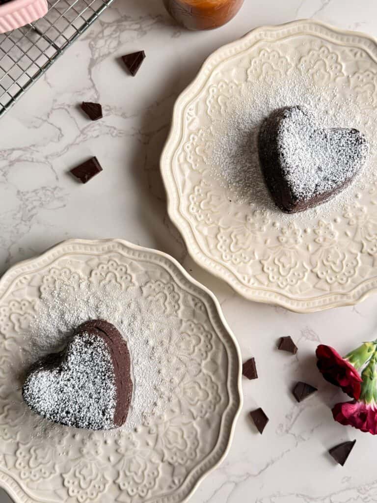 salted caramel molten lava cakes on white plates dusted with powdered sugar 