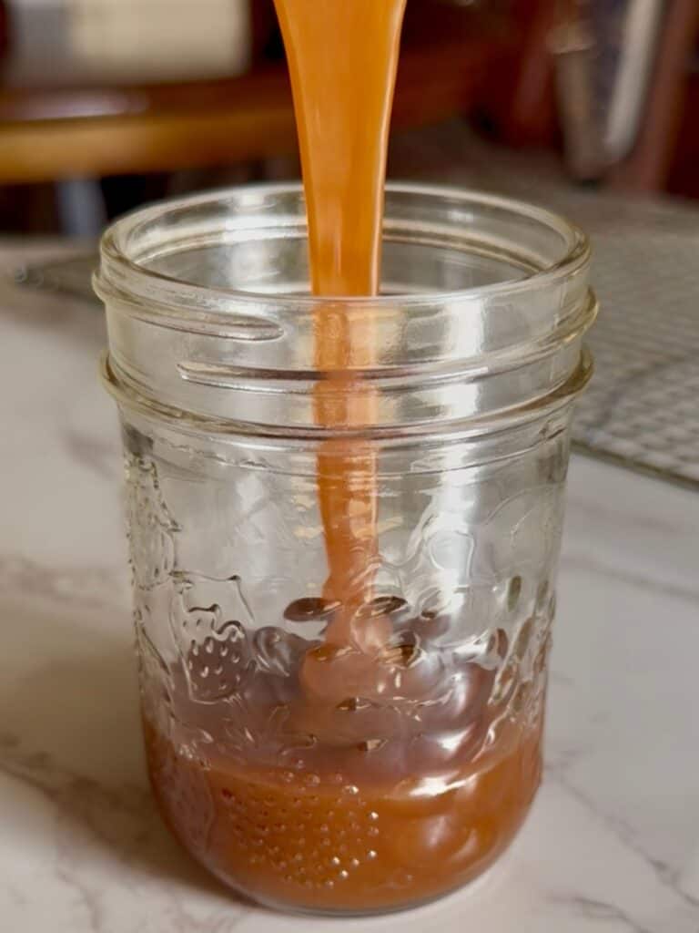 salted caramel molten lava cakes - salted caramel being poured into a jar