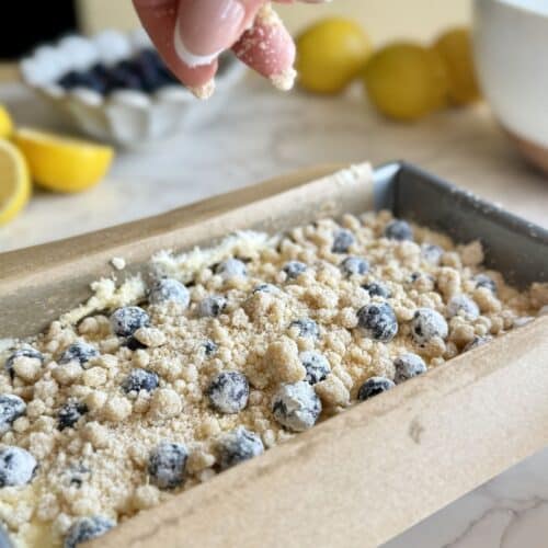 crumbling streusel over lemon blueberry loaf cake