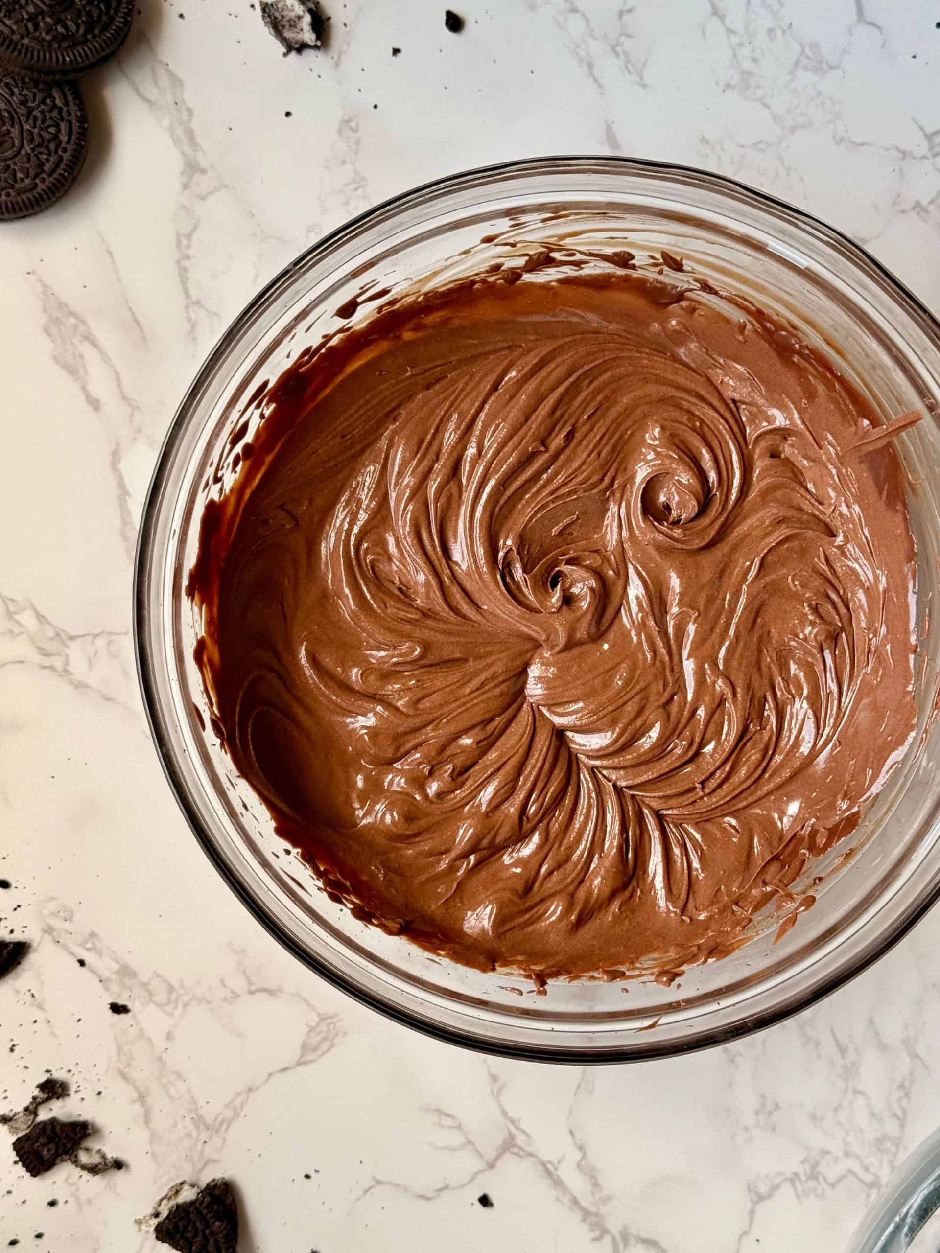 bowl of whipped chocolate ganache showing the fluffy texture and whipped to soft peaks