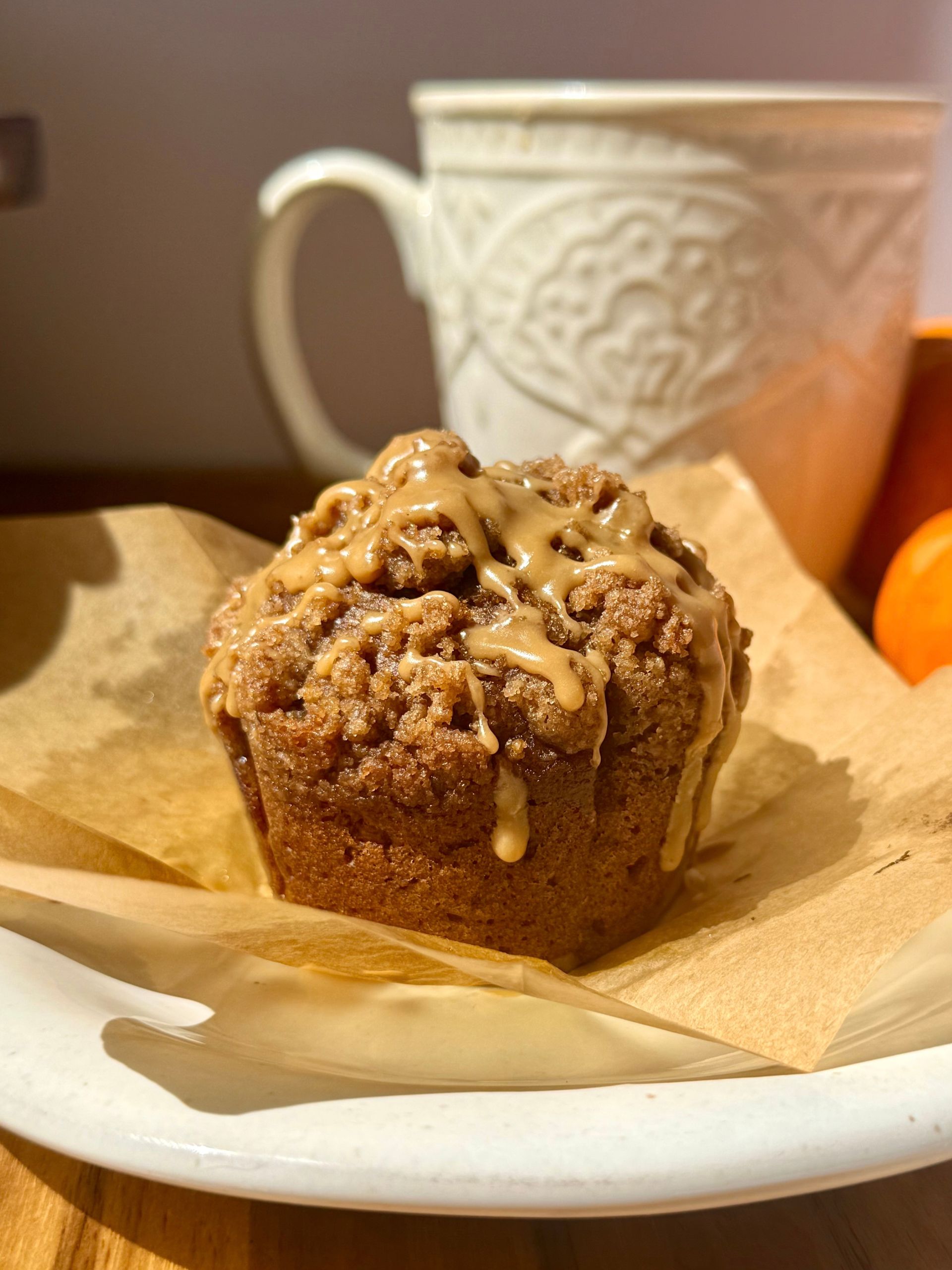 pumpkin spice latte muffin with espresso glaze drizzled on top 