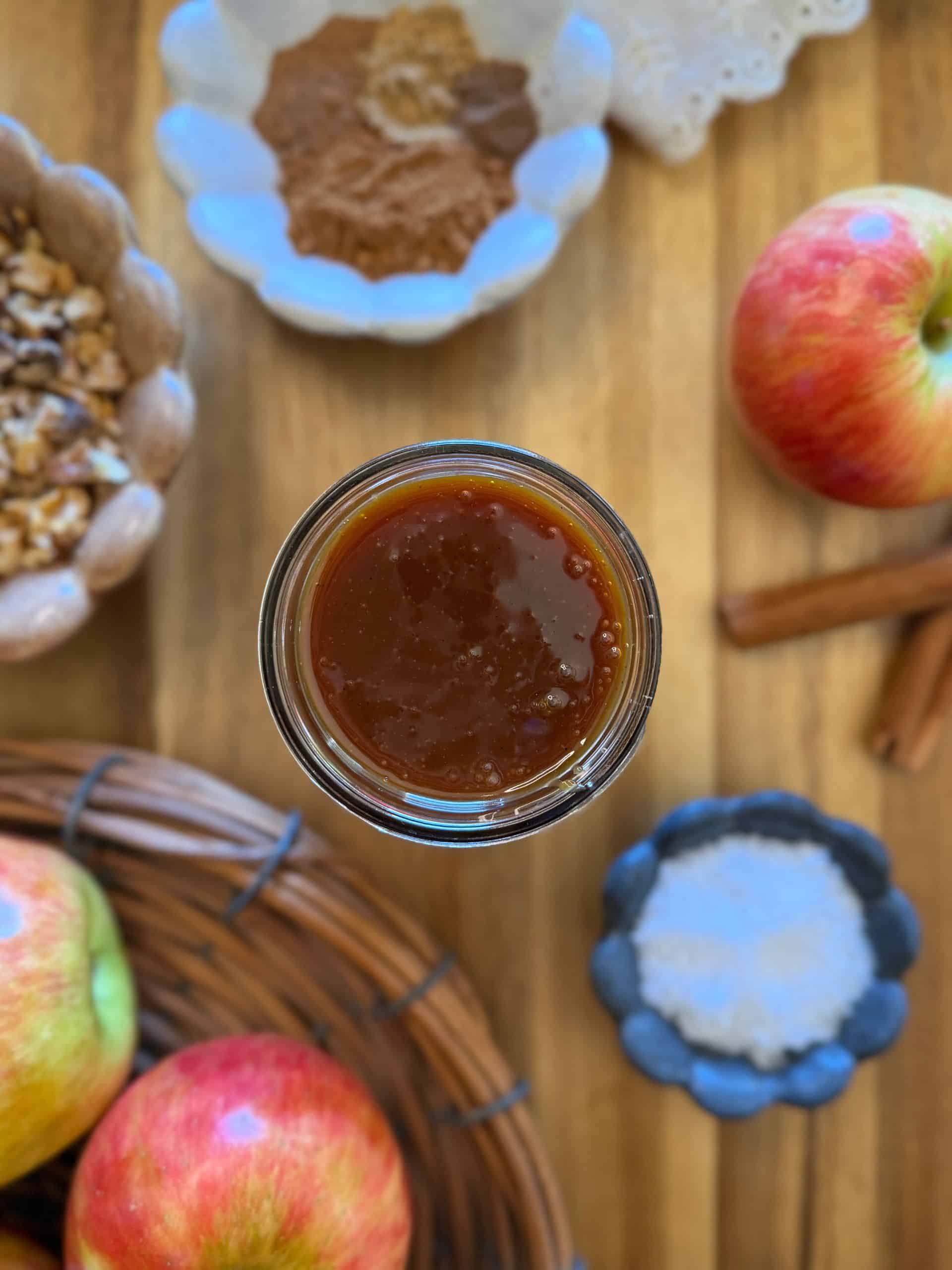 deep golden salted caramel in jar with apple cake ingredients
